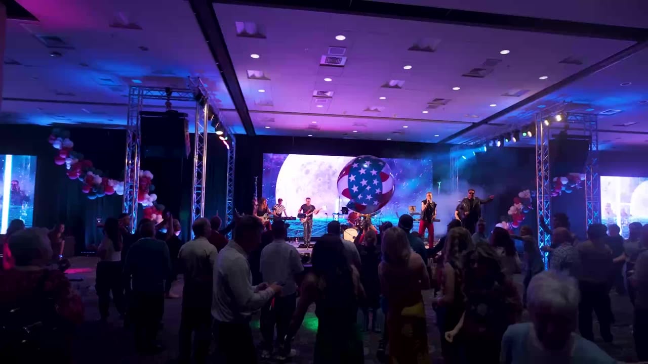 Crowd celebrating under concert lighting