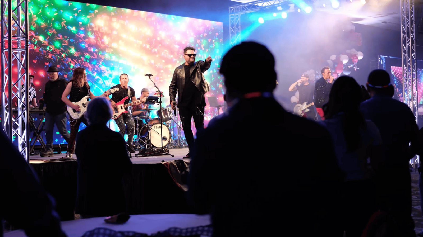 The live band lighting up the room with the crowd on their feet