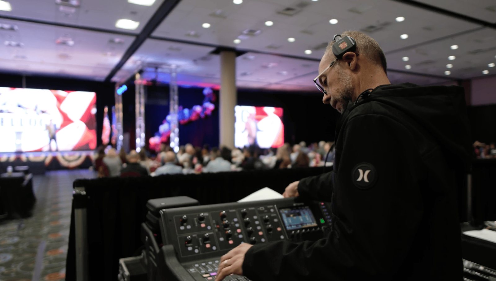 A True AV engineer mixing front-of-house sound at the Kellogg summit
