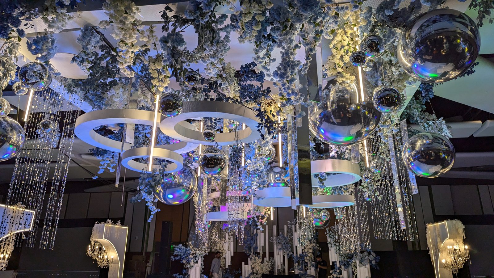 Floral and chandelier decor lit in blue